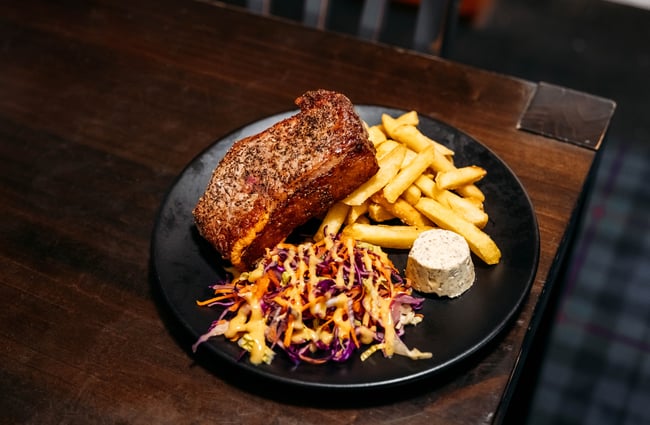 Steak and chips on a plate.