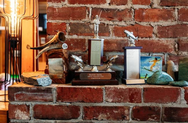 Awards on a fireplace.
