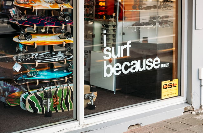 A 'I surf because ...' sign on a retail store window.