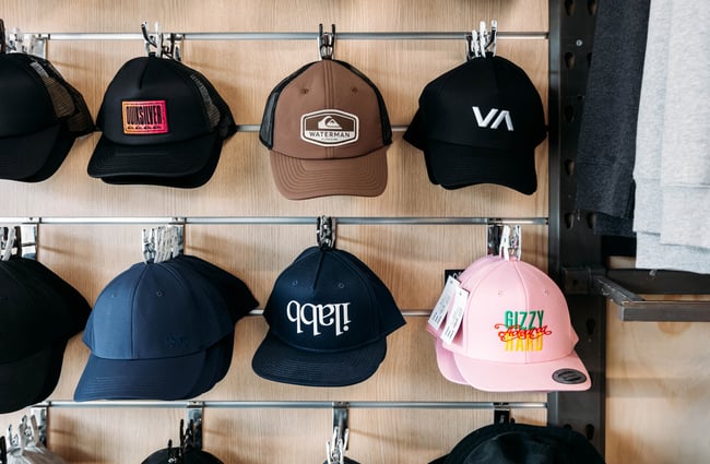 A close up of colourful caps on display in a retail store.