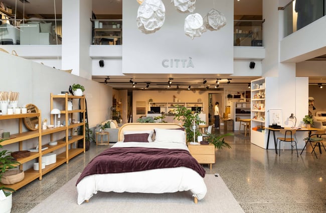 A bed setting in a large open space.
