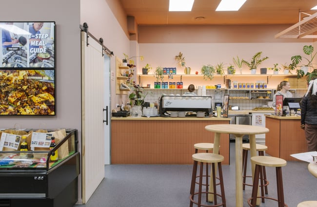 Seating area and view of the coffee machine at Blue Moon Bakehouse.