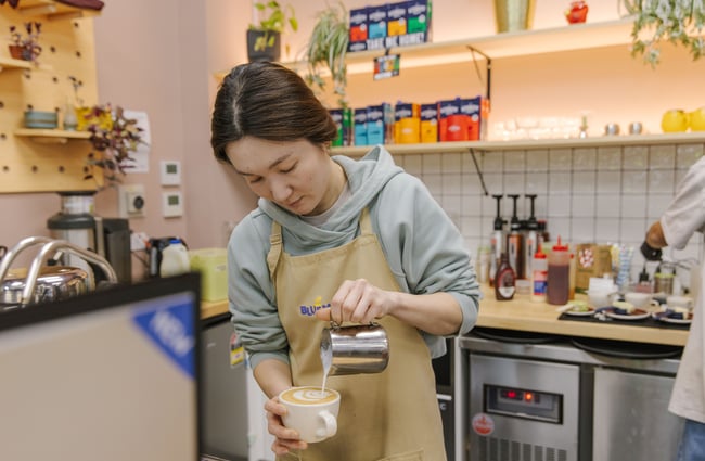 Barista pouring a coffee at Blue Moon Bakehouse.