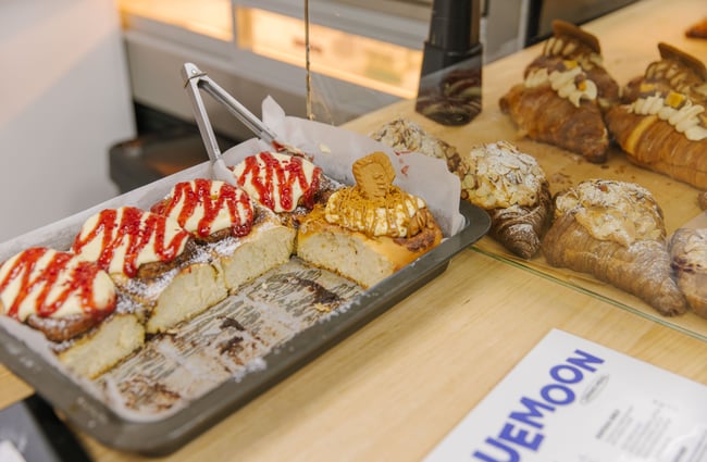 Tray of baked goods waiting to be placed in the cabinet at Blue Moon Bakehouse.