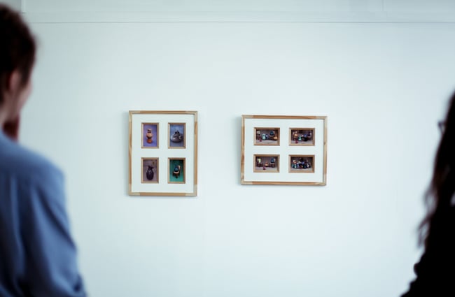 Looking at artwork on a white wall.