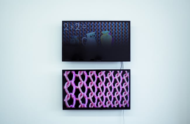 Two pieces of artwork next to each other on a white wall.