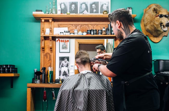Barber giving man a hair cut.