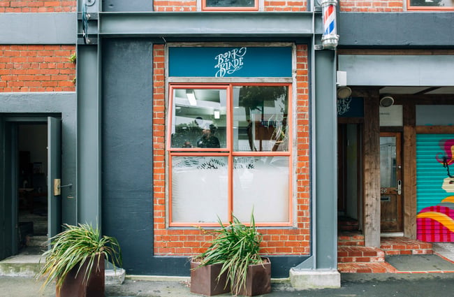 Barber shop front with planters out the front.
