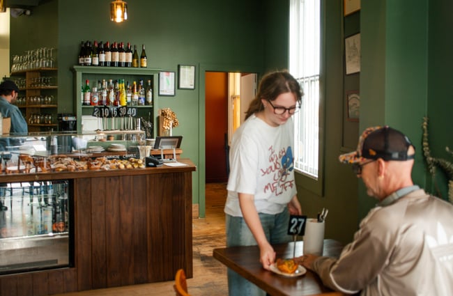 Customer being given their order at Bodega.