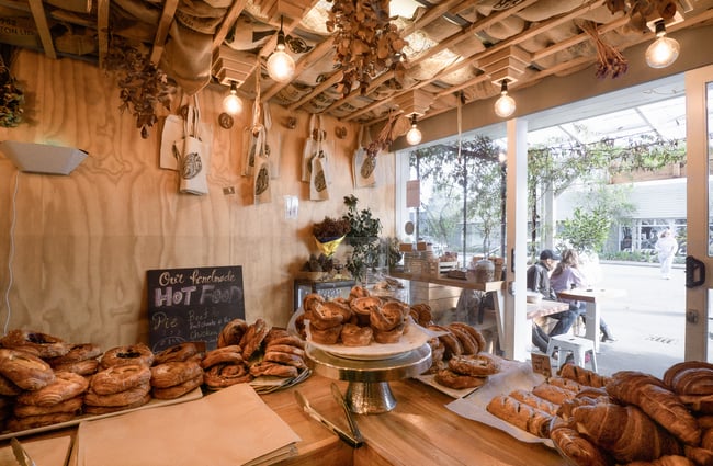 Pastries on a counter top inside a dimly lit cafe.