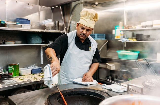 A man cooking in a restaurant.