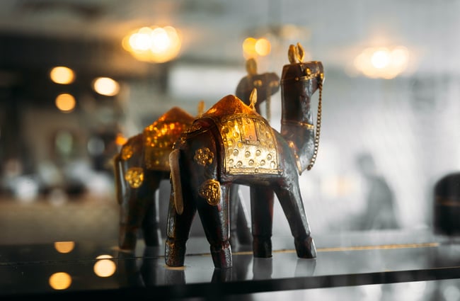 A close up of a camel decoration on a sill.