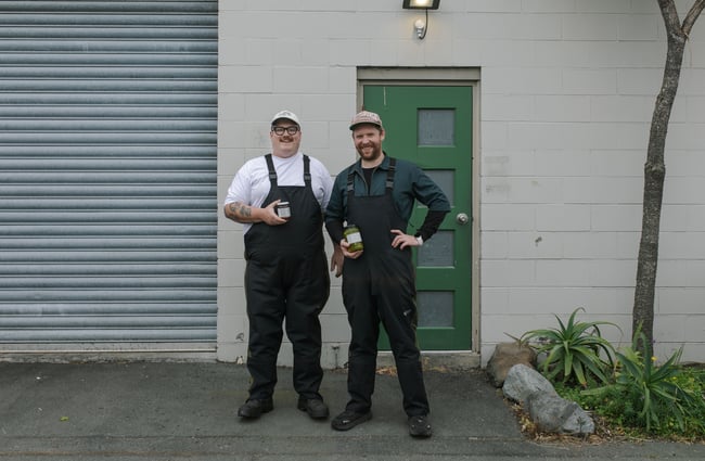 Chefs Mike and Max standing outside the kitchen of Bones Pickles.
