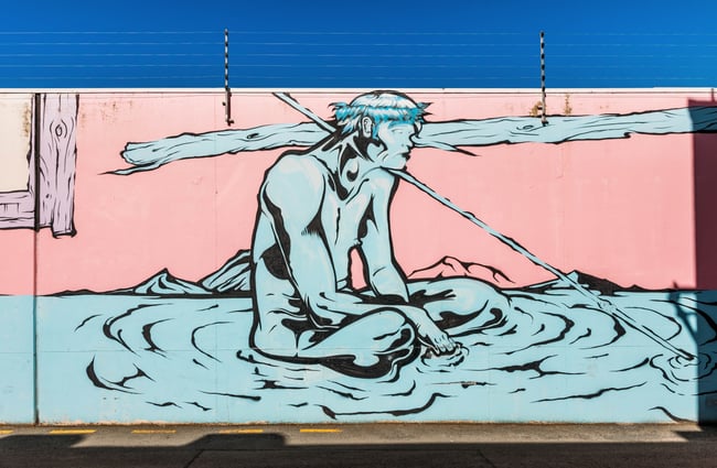 A colourful painted mural of a blue man.