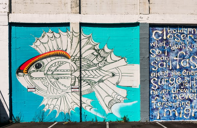 A colourful painted mural of a fish skeleton.