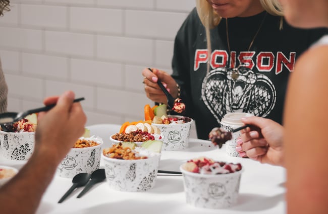 Customers enjoying smoothie bowls at Bowl and Arrow.