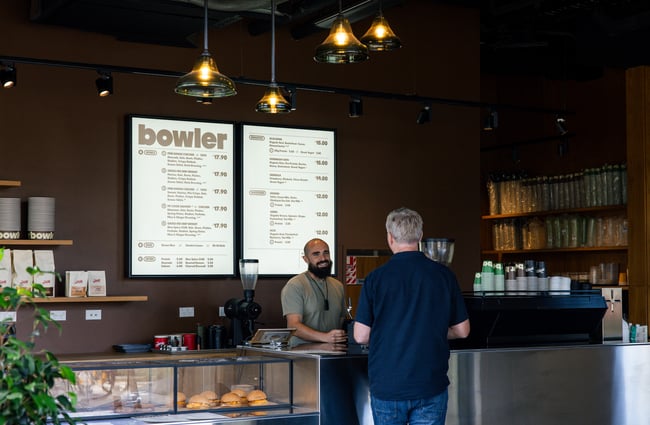 Customer being served at the counter at Bowler.