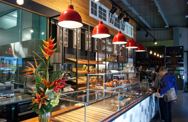 Food on display with red hanging lights.