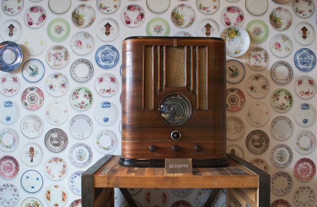 Retro radio against plate wallpaper.