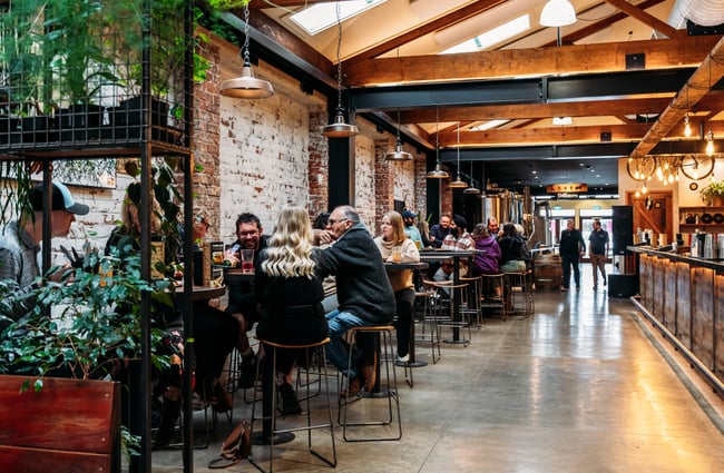 Customers sitting at tables at Brew Union.