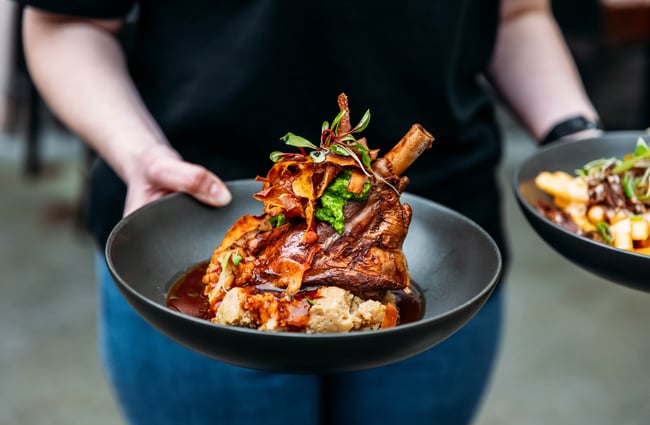 Wait staff serving some food dishes at Brew Union.
