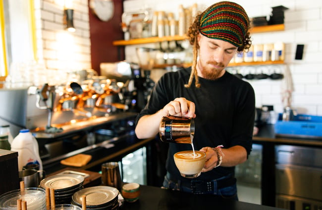 Barista pouring a coffee at Brewed As.