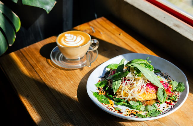 Coffee and a plate of food on the table at Brewed As.