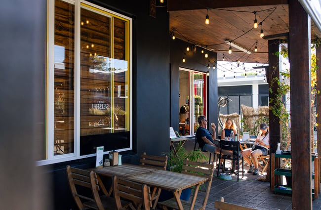 Diners sitting outside at Brewed As.