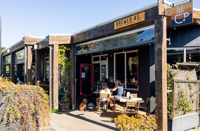 Table of diners outside Brewed As.