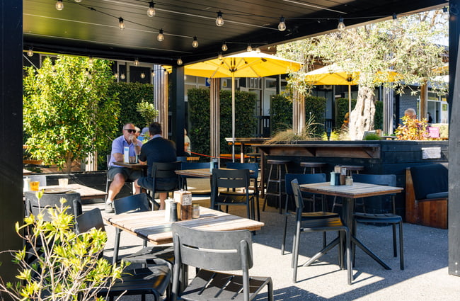 Outdoor dining space at Brewed As.
