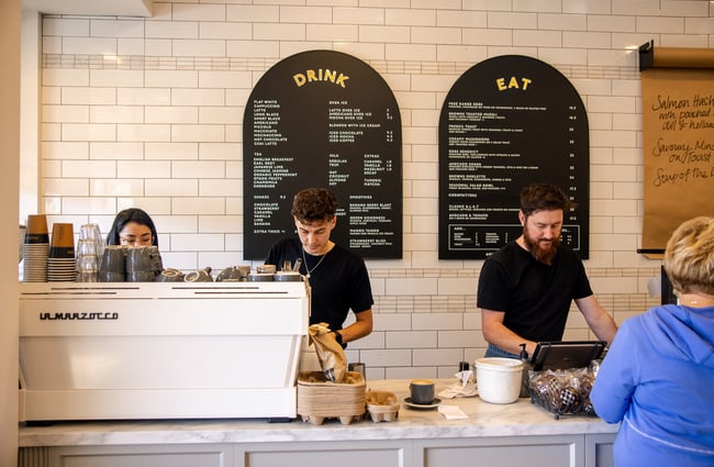 Staff members working behind the counter at Browns Eatery.