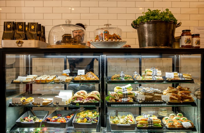 Sandwiches and other lunch items on display inside a glass cabinet.