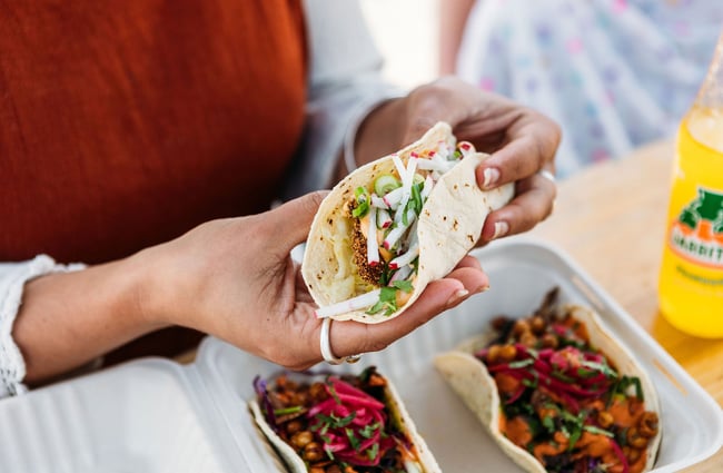 Close up of a person's hands holding a taco.