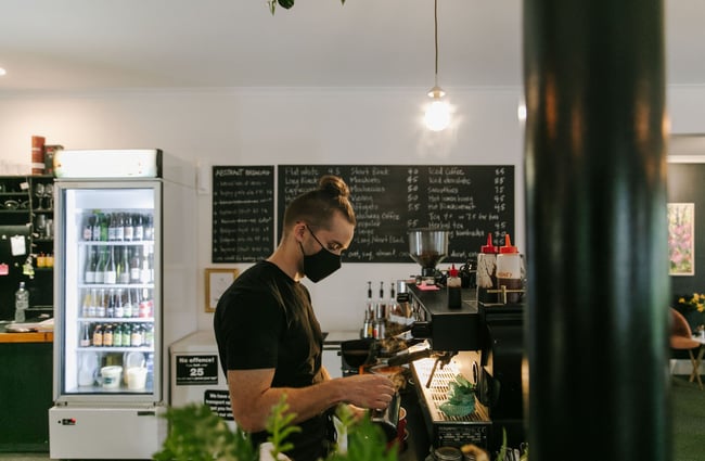 A barista wearing a mask making coffee at Cafe Verdé in Geraldine.