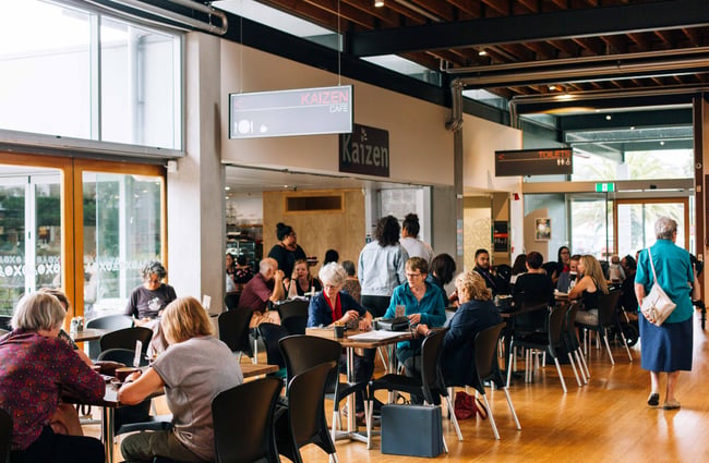 Cafe interior showing tables and patrons.