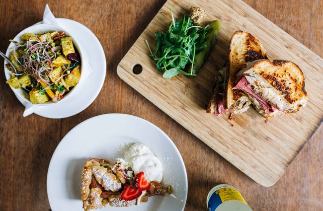 Table of food on plates and wooden boards.