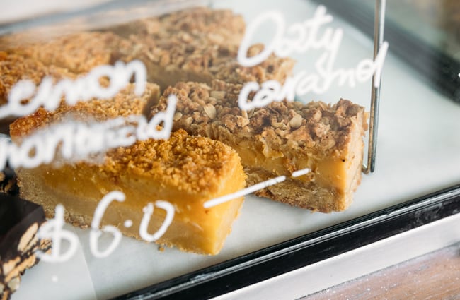 A close up of two slices in a glass cabinet.