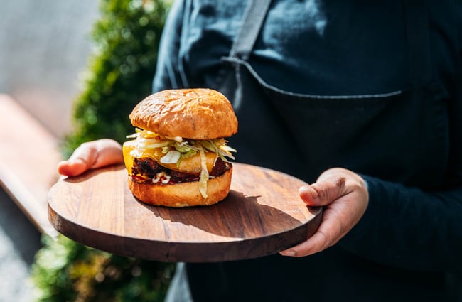 Burger on a board at Cambridge Lane.
