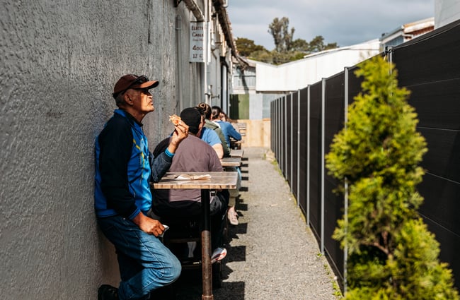 Customers sitting at outdoor tables in the sun at Cambridge Lane.