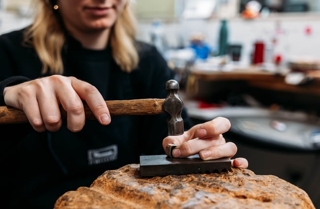 A jeweller making a piece of jewellery at Cameron Jewellery.