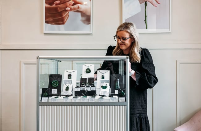 Shop assistant getting something out of the jewellery cabinet at Cameron Jewellery.