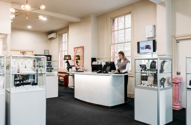 Display cabinets with jewellery and front counter in the showroom of Cameron Jewellery.