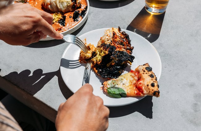 A person tucking into a plate of food.