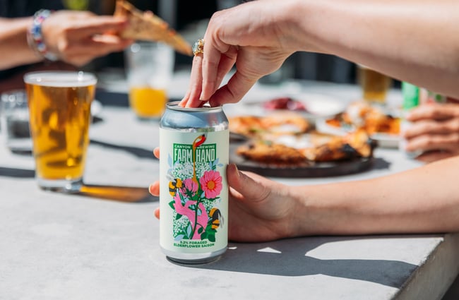 Hands opening a can of beer.