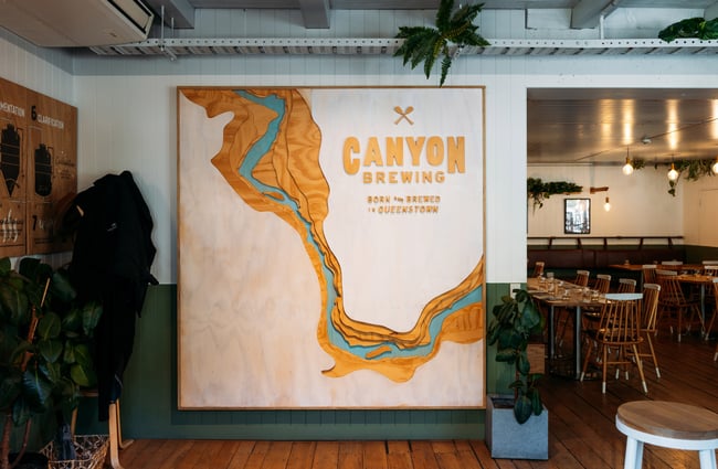 A large 'Canyon Brewing' sign on a wall.
