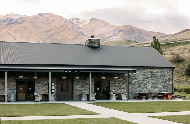 Cardrona Distillery building in front of the mountains.