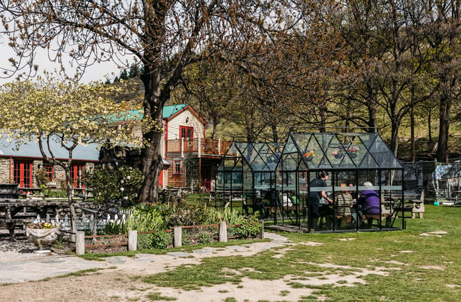 The garden area at Cardrona Hotel with a couple of glass-enclosed dining pods.