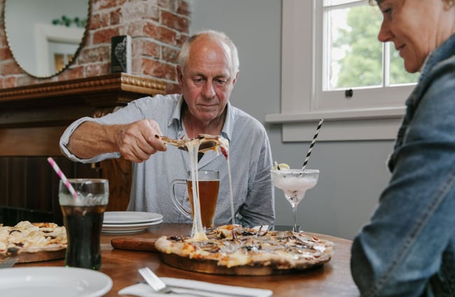 Man serving up pizza at Carnegie's Restaurant and Bar, Fairlie.