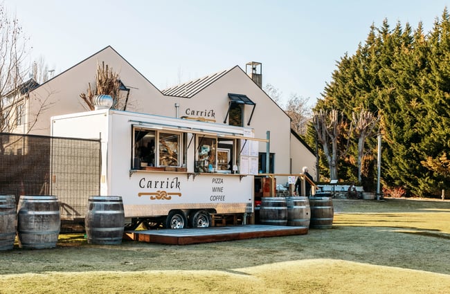 A food caravan on grass outside Carrick Winery Bannockburn Central Otago.