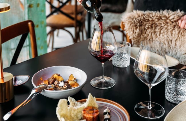 A close up of food and wine on a table.